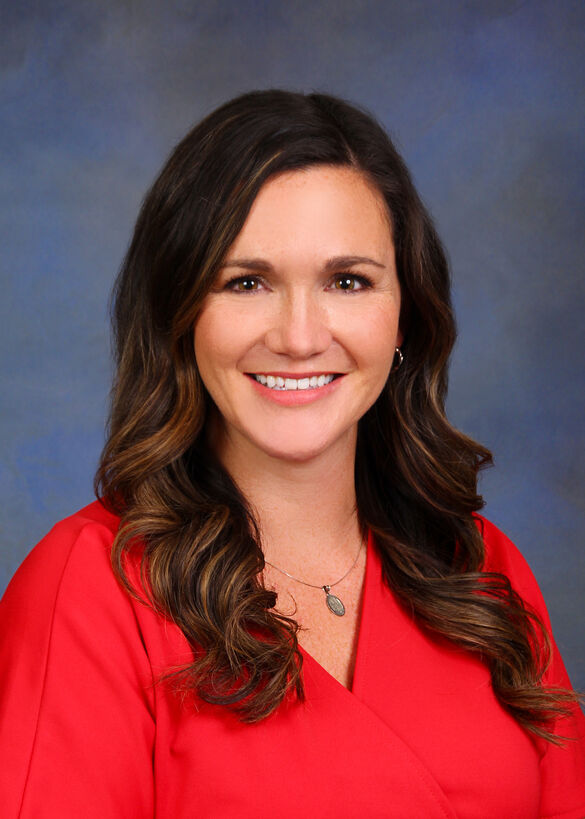 headshot of white woman with brown hair smiling